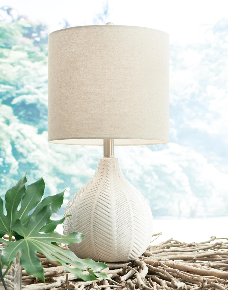 Ashley Furniture Rainermen Lamp Set featuring two stylish table lamps with fabric shades and wooden bases on a modern side table.
