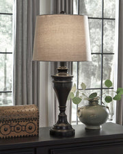 Pair of Ashley Furniture Darlita table lamps with beige fabric shades and decorative bases, perfect for bedside or living room decor.