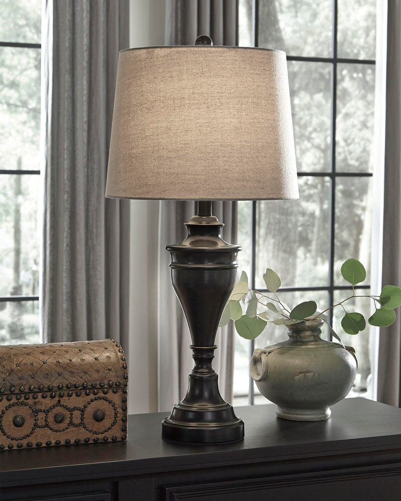 Pair of Ashley Furniture Darlita table lamps with beige fabric shades and decorative bases, perfect for bedside or living room decor.
