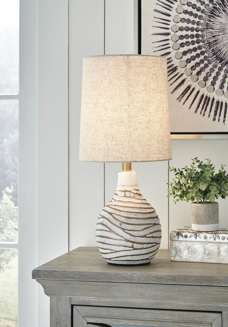 Ashley Furniture Aleela table lamp with a sleek base and fabric shade, perfect for bedside or living room lighting.