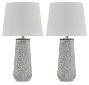 Pair of Ashley Furniture Chaston table lamps with beige drum shades and bronze bases, placed on a wooden surface.