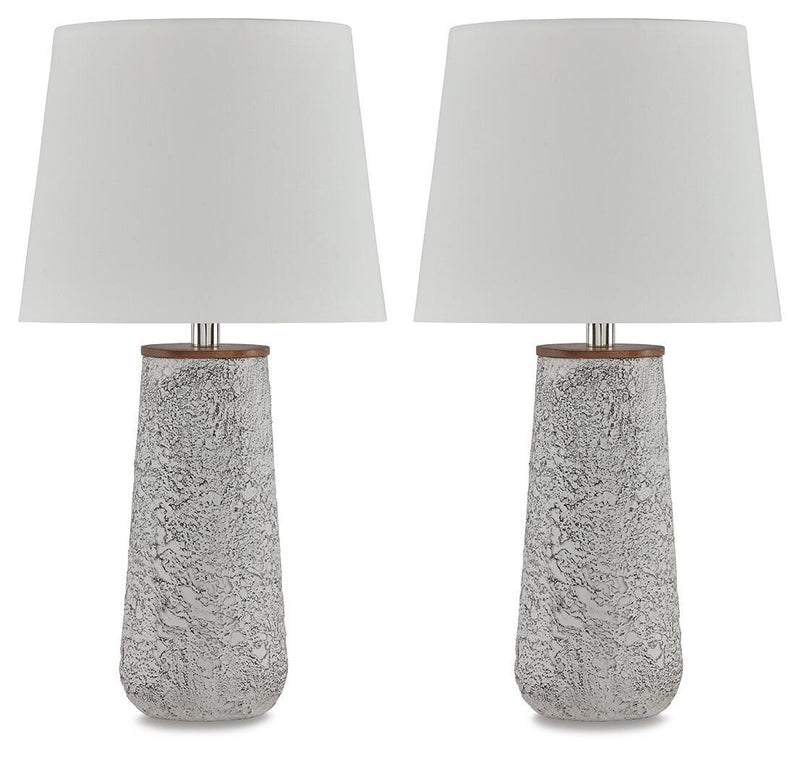 Pair of Ashley Furniture Chaston table lamps with beige drum shades and bronze bases, placed on a wooden surface.