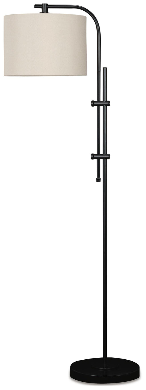 Ashley Furniture Baronvale floor lamp with a tall, modern design and a sleek metal finish, standing on a wooden floor.