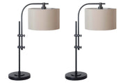 Ashley Furniture Baronvale Lamp Set featuring two stylish table lamps with beige shades and decorative bases on a wooden surface.
