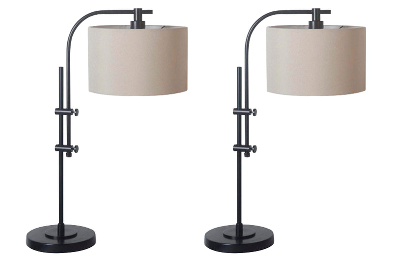 Ashley Furniture Baronvale Lamp Set featuring two stylish table lamps with beige shades and decorative bases on a wooden surface.