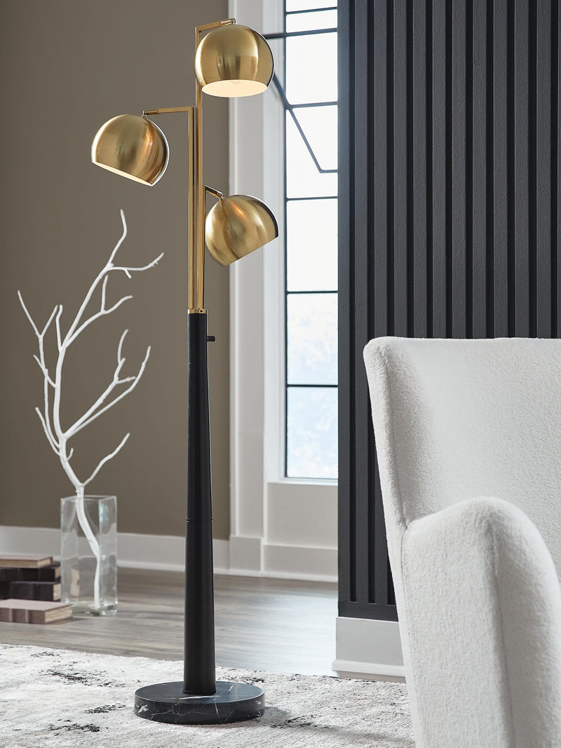 Ashley Furniture Sorcha floor lamp with a sleek design and fabric shade, standing on a wooden base in a modern living space.