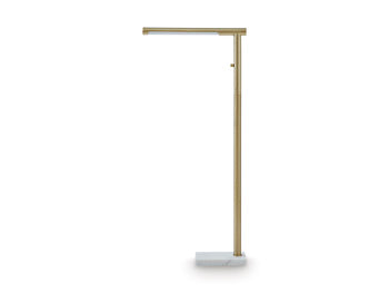 Ashley Furniture Santiford floor lamp with a sleek design and tall, modern structure standing on a hardwood floor.