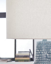Ashley Furniture Schylarmont table lamp set with detailed beige fabric shades and wooden bases, ideal for bedroom or living room decor.