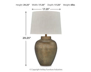 Madney Table Lamp Set by Ashley Furniture featuring two stylish ceramic lamps with fabric shades on a wooden table.