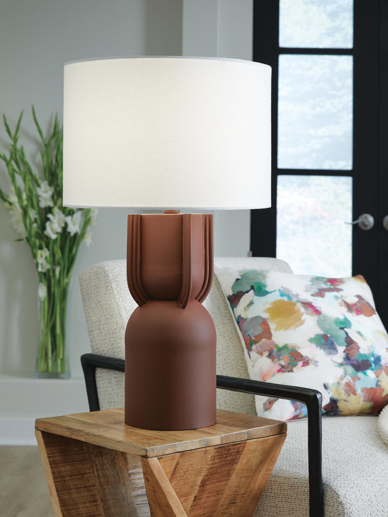 Ashley Furniture Rowandale table lamp with a classic design, featuring a fabric shade and decorative base on a wooden surface.