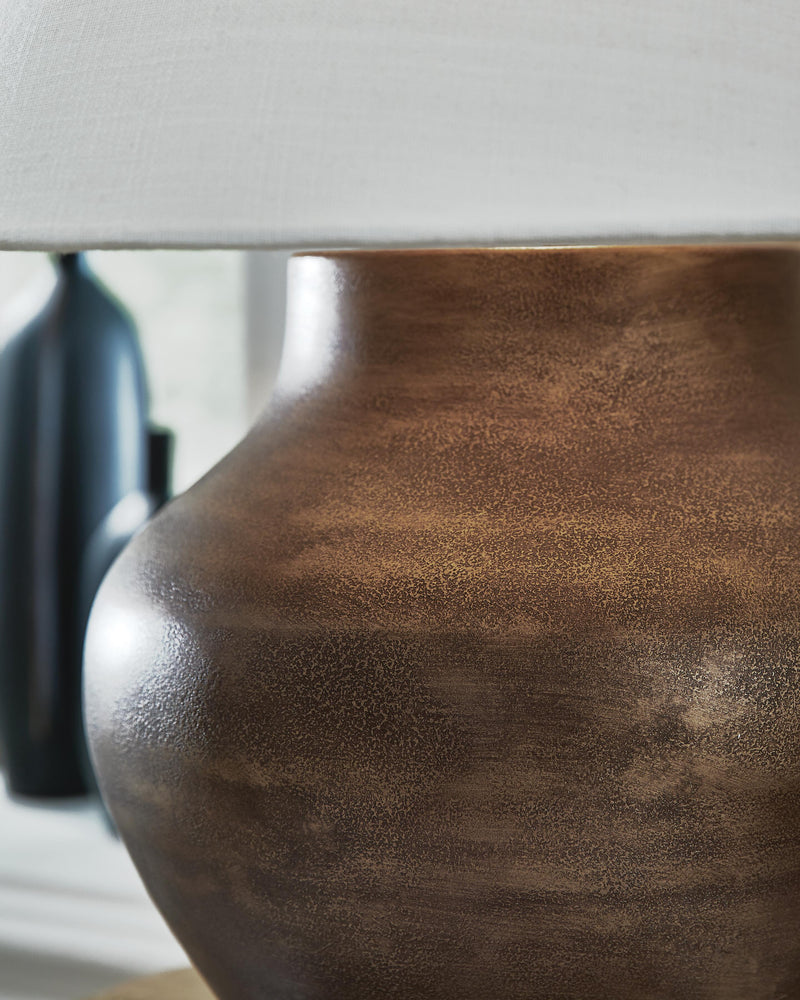 Ashley Furniture Whitham table lamp with a sleek design and fabric shade, perfect for bedside or living room decor.