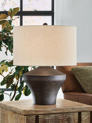 Ashley Furniture Dolanham table lamp with a sleek design, featuring a fabric shade and a sturdy base, ideal for modern home decor.