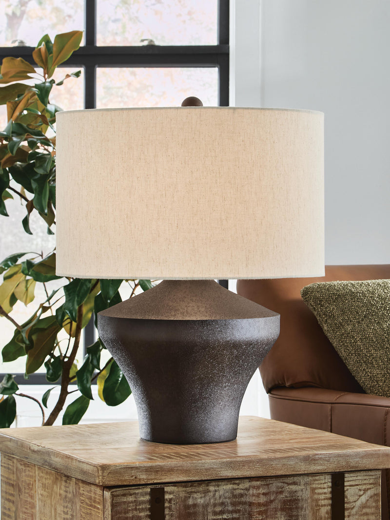 Ashley Furniture Dolanham table lamp with a sleek design, featuring a fabric shade and a sturdy base, ideal for modern home decor.