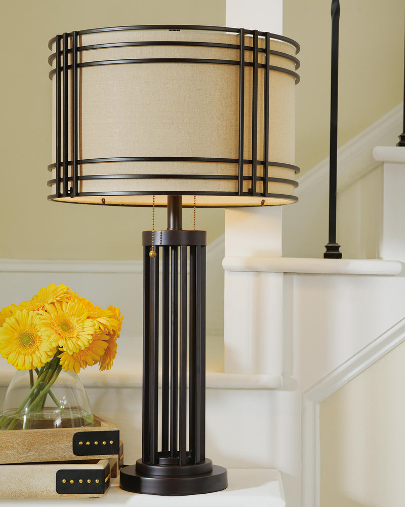 Ashley Furniture Hanswell table lamp set with modern design, featuring two stylish lamps with fabric shades and sleek bases.