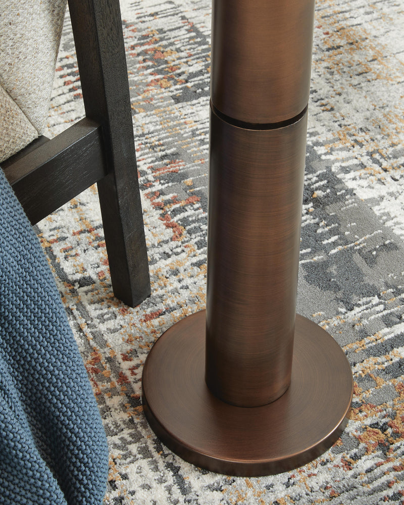 Close-up of the base of the Ashley Furniture Wendfield Floor Lamp, showcasing its design and finish.