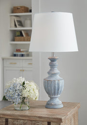 Ashley Furniture Cylerick table lamp with a sleek ceramic base and fabric shade, ideal for modern living room or bedroom decor.
