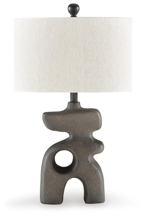 Ashley Furniture Danacy table lamp with a sleek design, featuring a modern base and a fabric lampshade on a wooden table.