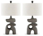 Ashley Furniture Danacy table lamp set with two stylish lamps featuring neutral-colored shades and modern bases.