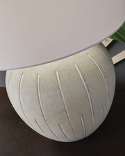 Ashley Furniture Calbert Table Lamp with a sleek ceramic base and fabric lampshade, ideal for modern living room decor.