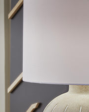 Ashley Furniture Calbert table lamp with a detailed shade and classic design, perfect for enhancing any living space.