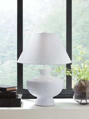 Ashley Furniture Harelwood table lamp with a textured ceramic base and fabric shade on a wooden side table