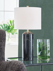 Hanzila table lamp by Ashley Furniture with a sleek base and fabric lampshade, ideal for modern living room or bedside decor.