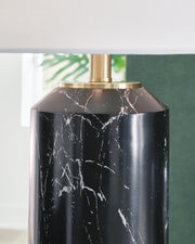 Ashley Furniture Hanzila table lamp with a sleek design, featuring a ceramic base and fabric shade for stylish lighting.