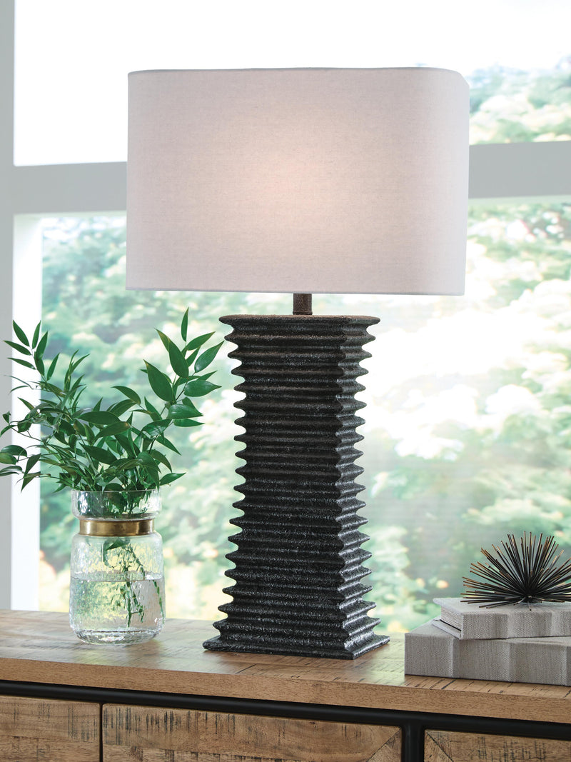 Ashley Furniture Golzar table lamp with a sleek base and fabric shade, ideal for modern living room or bedside decor.