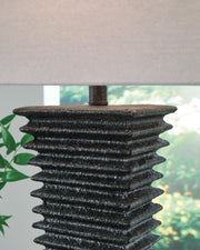 Ashley Furniture Golzar table lamp with decorative base and fabric shade, perfect for adding ambient lighting to a living space.