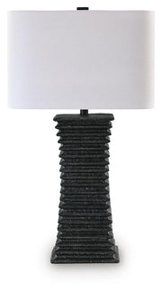 Ashley Furniture Golzar table lamp with a sleek design, featuring a white shade and decorative base for stylish home lighting.