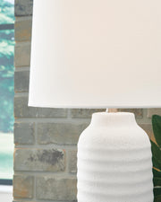 Pair of Vauville table lamps by Ashley Furniture with beige fabric shades and wooden bases, perfect for living room or bedside.