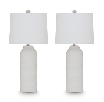 Pair of Vauville table lamps by Ashley Furniture with beige fabric shades and dark wood bases, placed on a wooden surface.