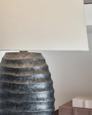 Pair of Caronick table lamps by Ashley Furniture with fabric shades and decorative bases, perfect for bedside or living room decor.
