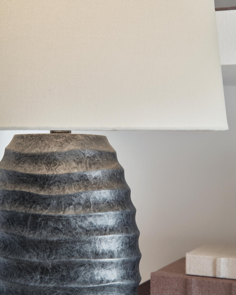 Pair of Caronick table lamps by Ashley Furniture with fabric shades and decorative bases, perfect for bedside or living room decor.