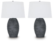 Pair of Ashley Furniture Caronick table lamps with beige fabric shades and wooden bases, ideal for bedside or living room decor.
