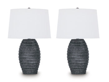 Pair of Ashley Furniture Caronick table lamps with beige fabric shades and dark wood bases on a wooden table.