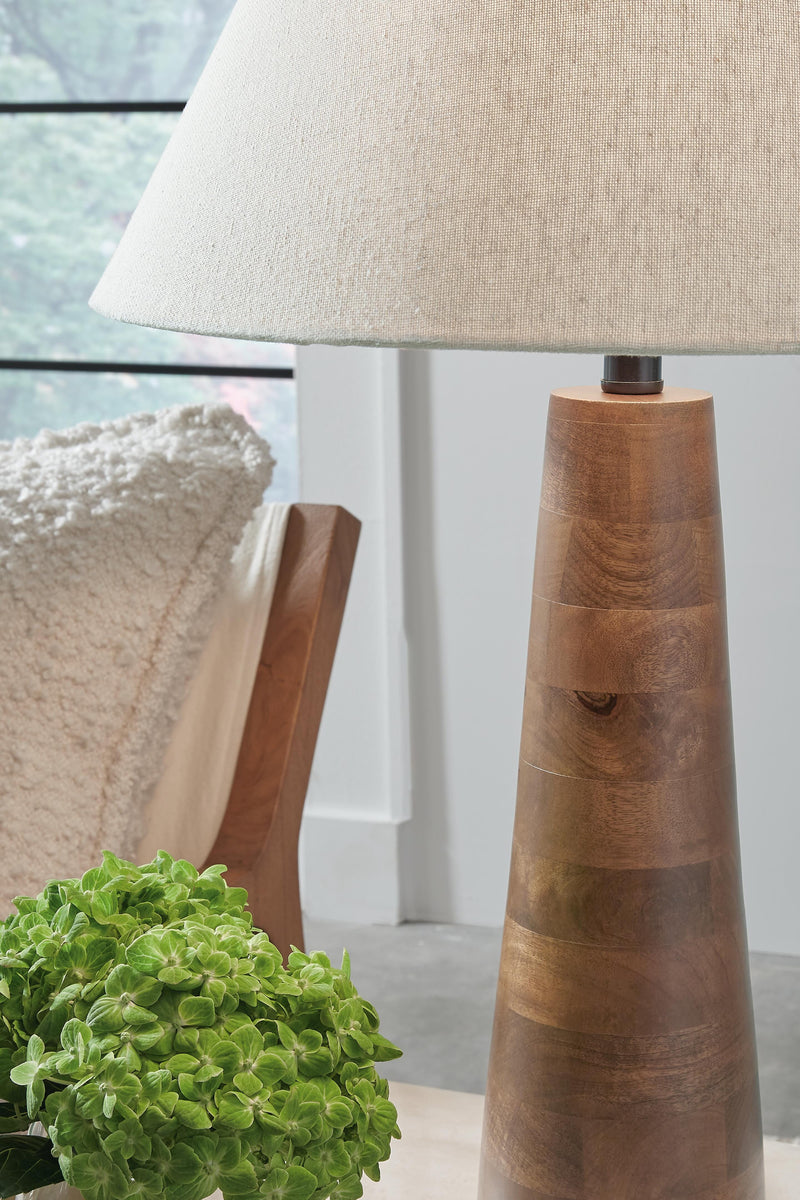Ashley Furniture Danset table lamp with a ceramic base and fabric shade, featuring a modern design and warm lighting.