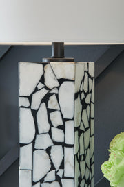 Ashley Furniture Macaria table lamp with a sleek base and fabric shade, ideal for bedside or living room decor.