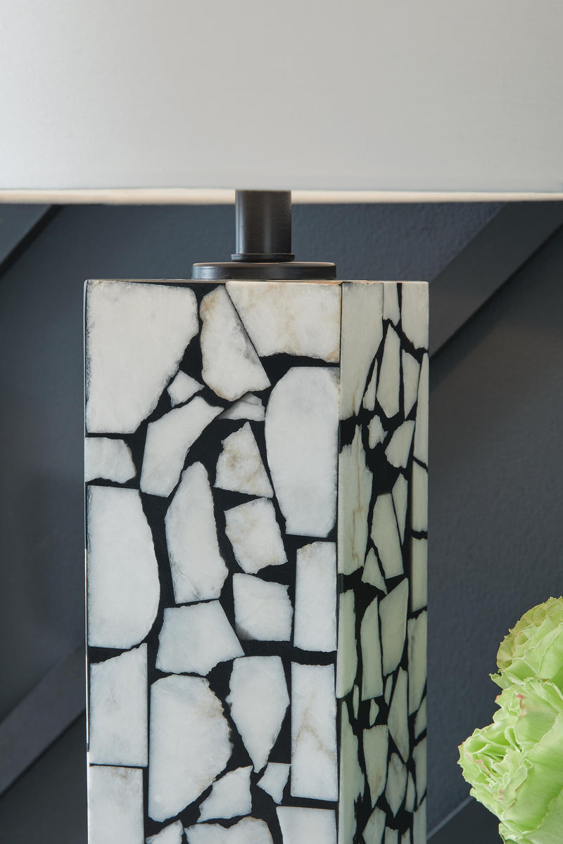 Ashley Furniture Macaria table lamp with a sleek base and fabric shade, ideal for bedside or living room decor.