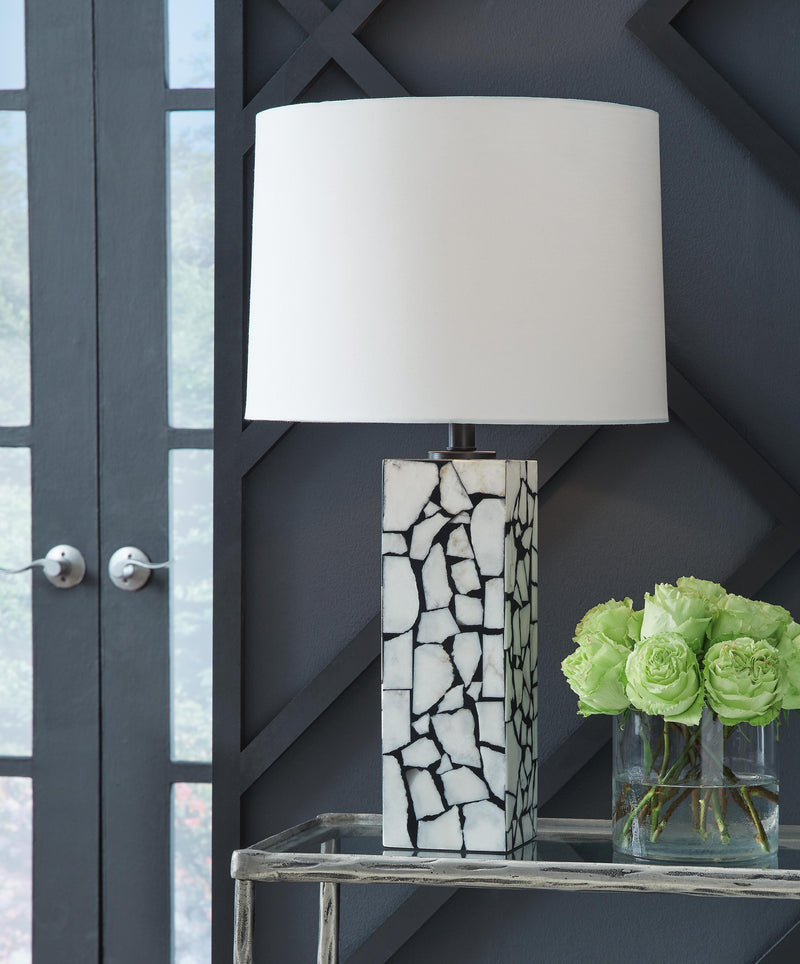 Ashley Furniture Macaria table lamp with a sleek base and fabric shade, perfect for desk or bedside lighting.