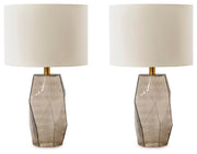 Ashley Furniture Taylor Lamp Set featuring two modern table lamps with beige shades and sleek bases.