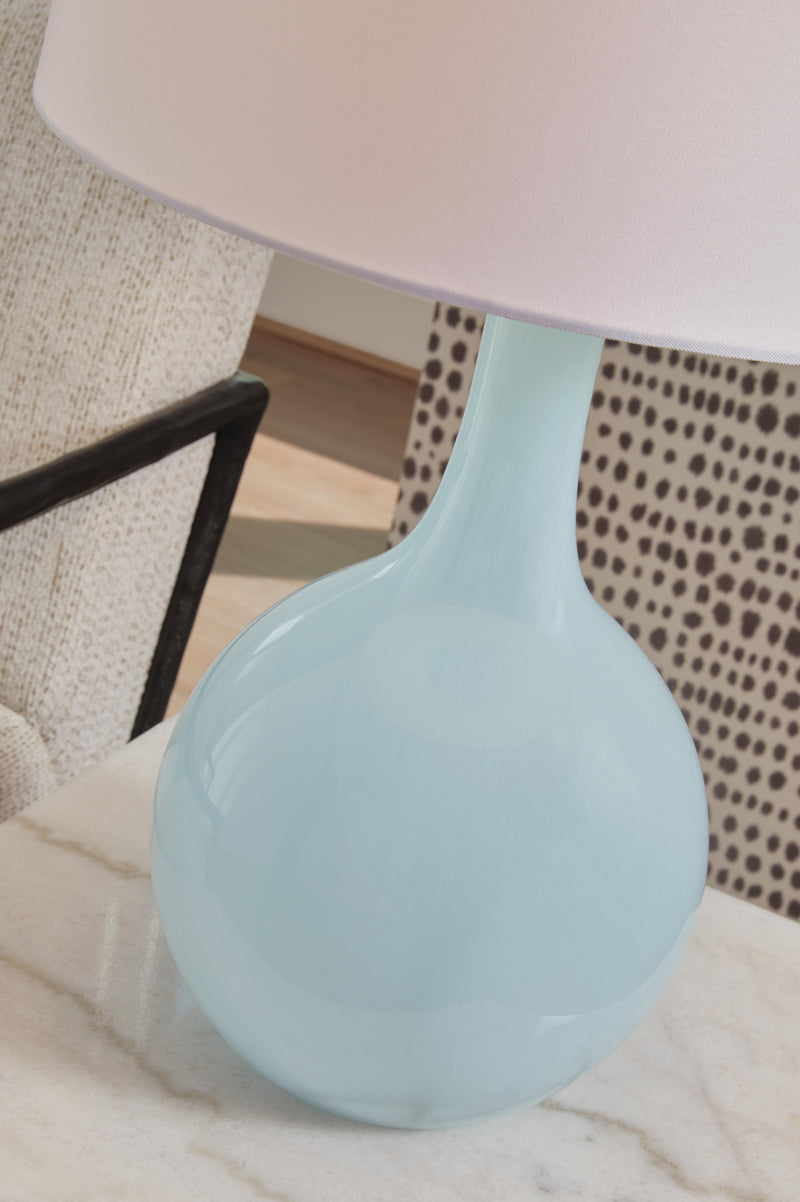 Close-up of the Rylanton table lamp by Ashley Furniture, featuring a sleek design with a fabric lampshade and decorative base.