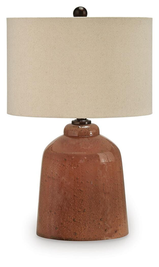 Aaleahya table lamp by Ashley Furniture featuring a stylish design with a fabric shade and decorative base on a wooden table.