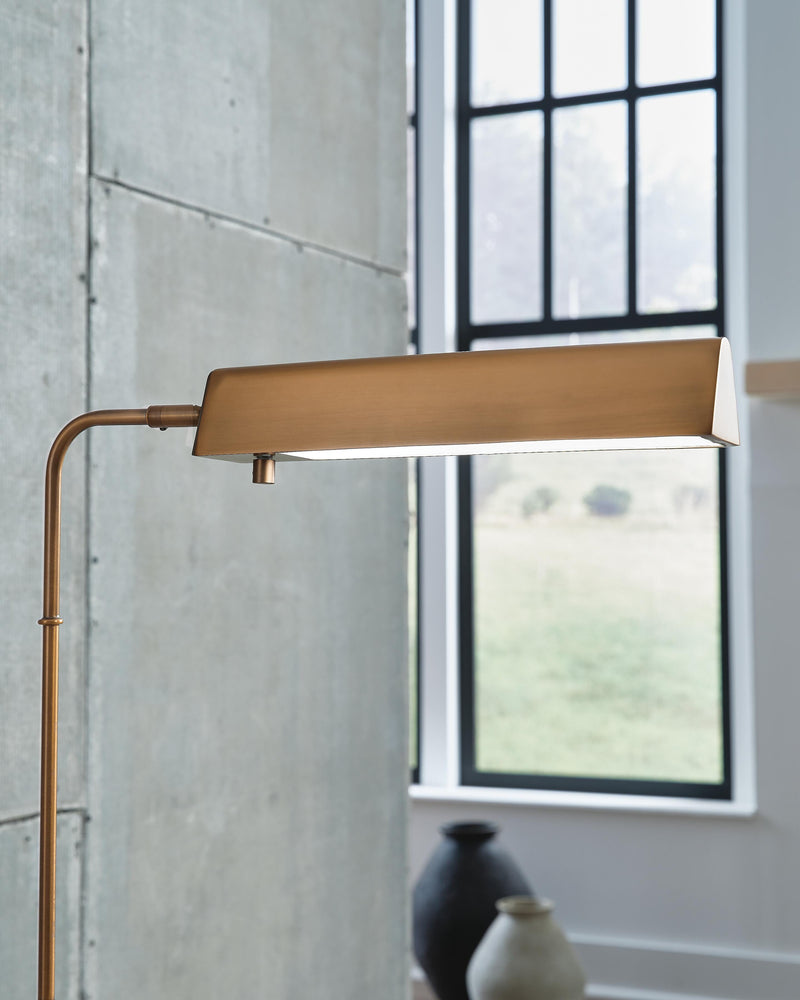 Ashley Furniture Yafe floor lamp with a sleek design and modern metal finish, standing tall with a fabric shade.