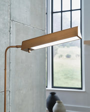 Ashley Furniture Yafe Floor Lamp with a sleek design, featuring a tall stand and modern light fixture for stylish room lighting.