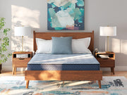 Ashley Furniture Peak 2.0 Bonnell Hybrid Mattress with plush surface and supportive coils, shown in a bedroom setting.