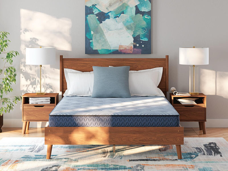 Ashley Furniture Peak 2.0 Bonnell Hybrid Mattress with plush surface and supportive coils, shown in a bedroom setting.