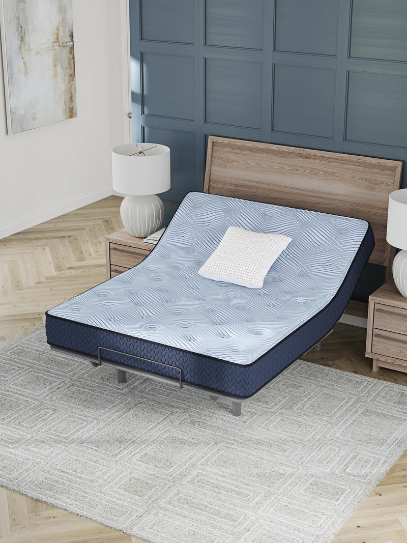 Ashley Furniture Peak 2.0 10 Hybrid Mattress showing a close-up of the mattress surface with quilted fabric and plush top.