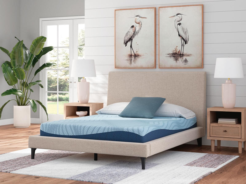 Ashley Furniture Peak 2.0 8-inch memory foam mattress with plush, supportive surface, shown on a bed frame in a bedroom setting.