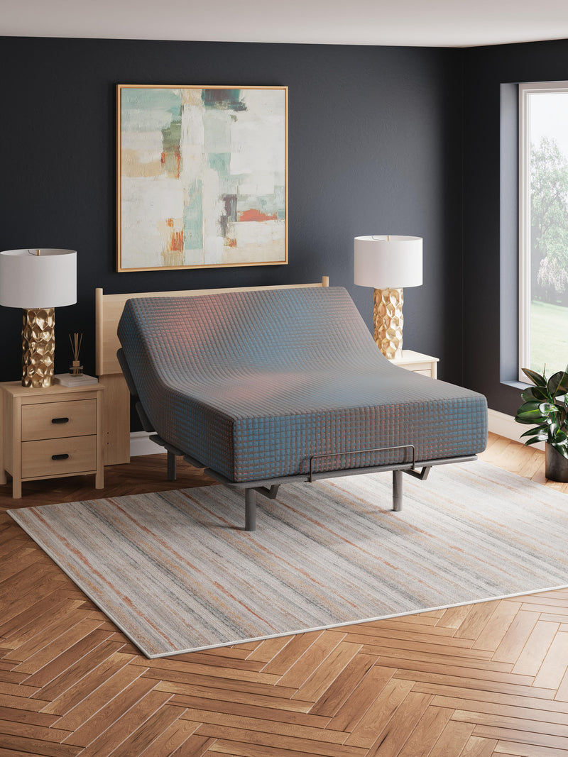 13-inch Ashley Furniture hybrid mattress with plush top and supportive design, shown in a neat, well-made bed setup.